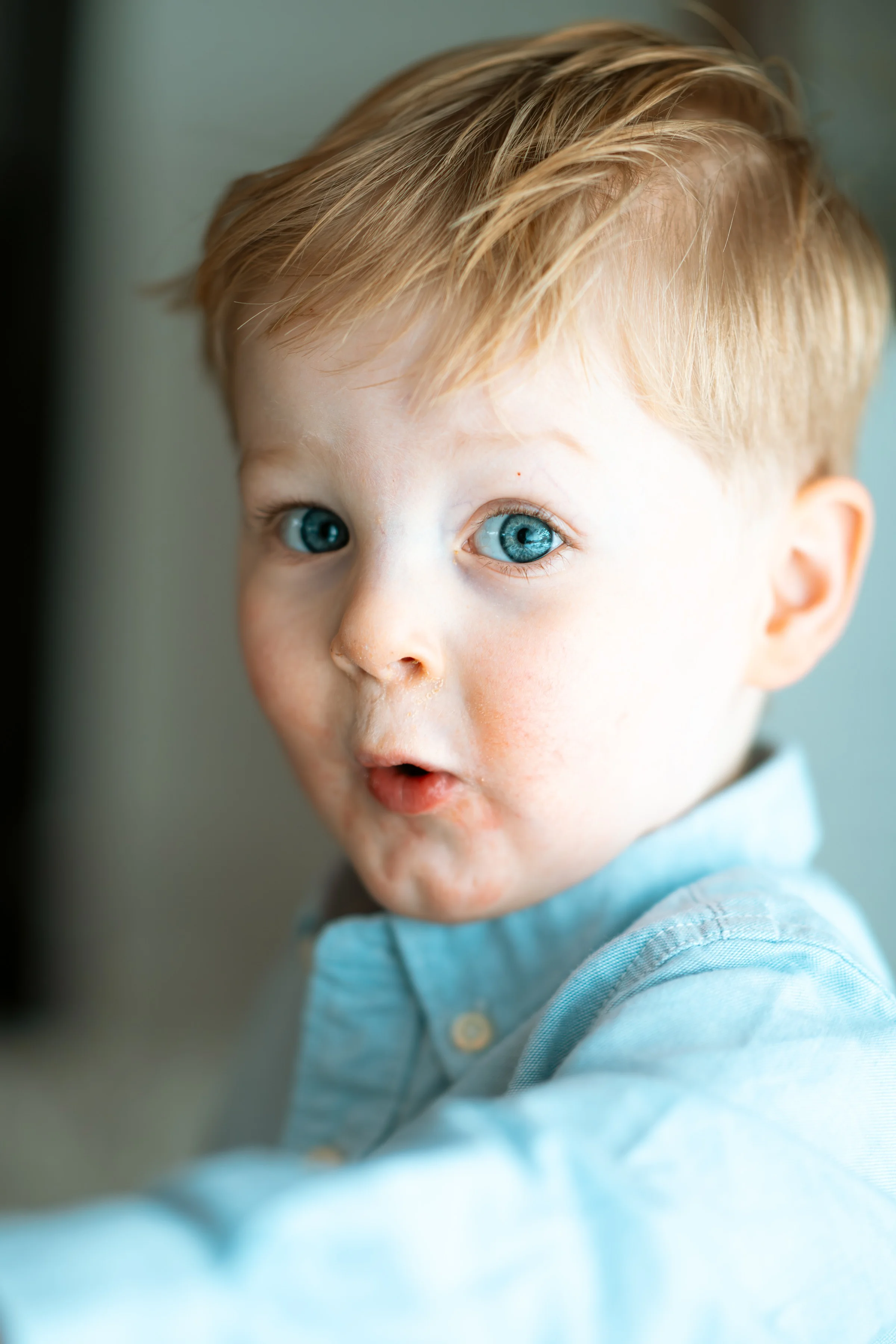 Close-up of a small boy in a light blue shirt