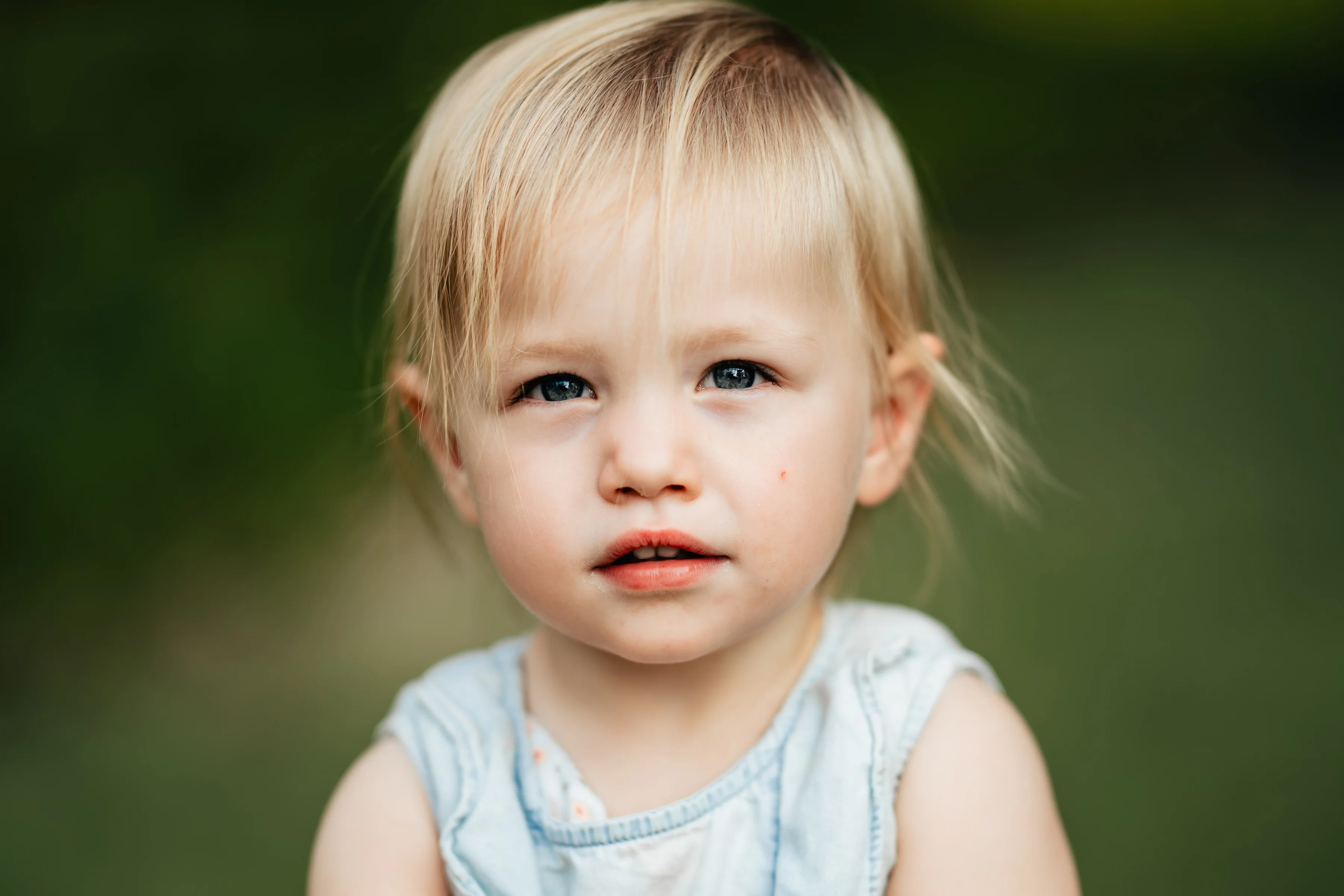 A smiling toddler in the park